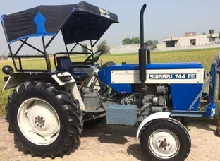 Blue And Black Tractor With Plow Blade